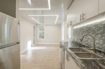 Потолок с глянцевым покрытием и световыми решениями на кухне